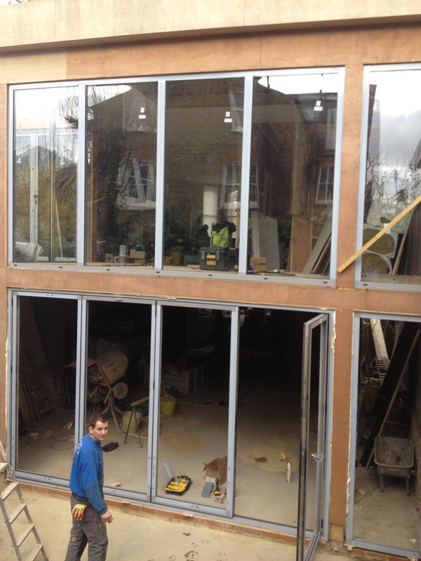 Aluminium bi-fold doors with two-storey glazing in Canning Town