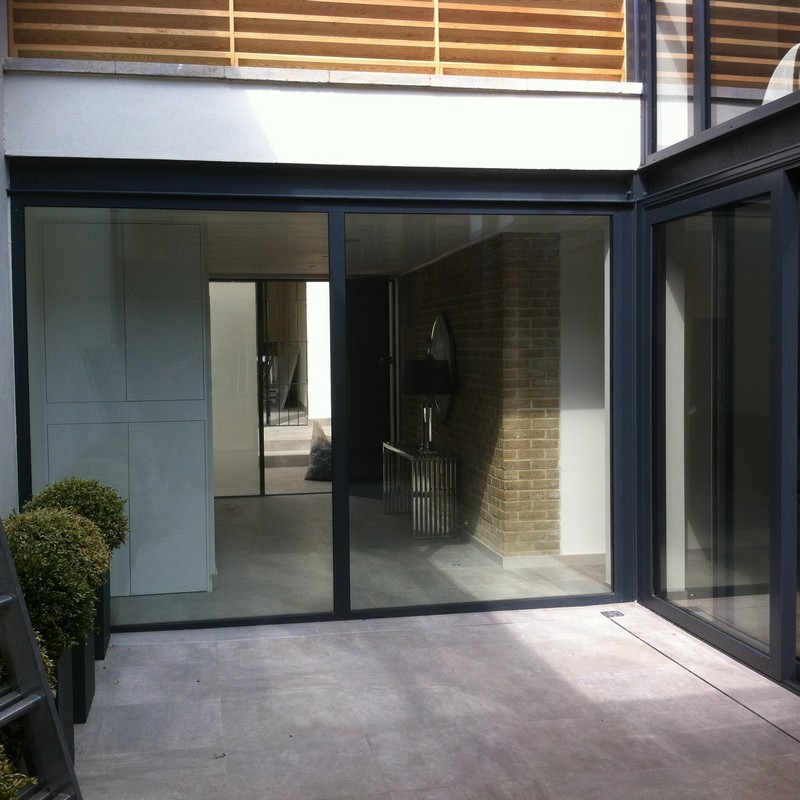 Floor-to-ceiling sliding doors opening to courtyard in Canning Town