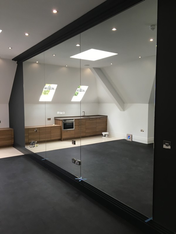 Frameless glass partition in loft conversion by Canning Town glaziers