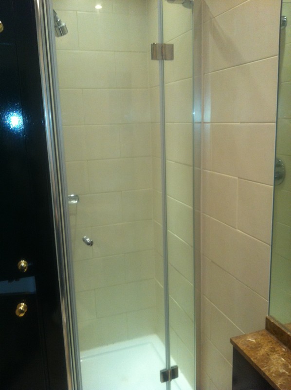Frameless glass shower enclosure with chrome fittings in Canning Town