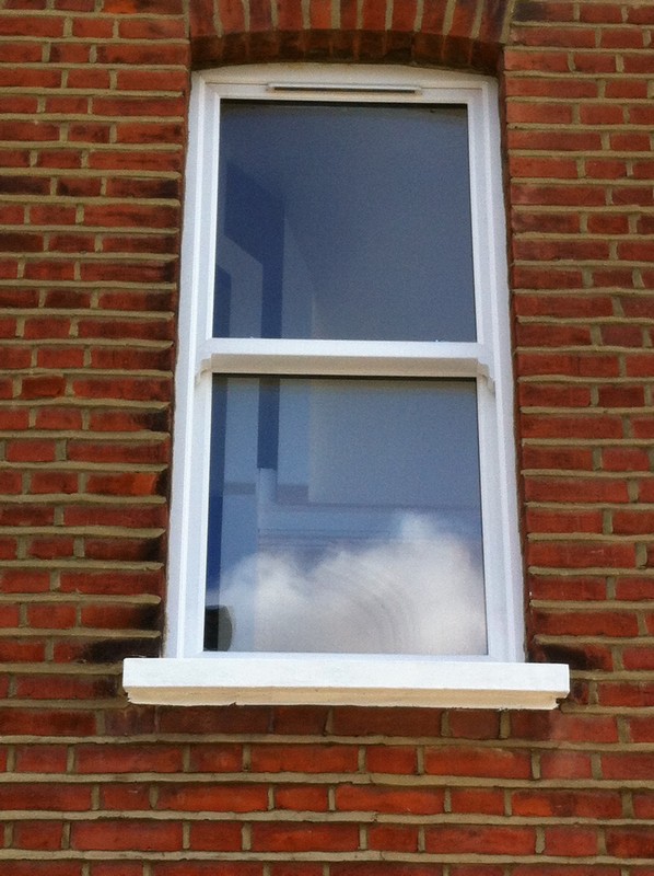 uPVC sash window on Victorian red brick house in Canning Town